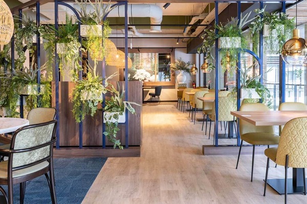 Unwind amid lush greenery and warm, designer pendant lighting.