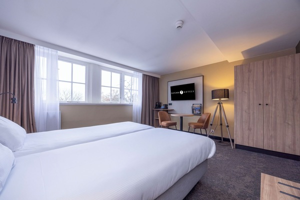 Wake up to soft daylight pouring through wide, airy windows.