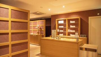A jewelry store interior with wooden display cases and a central counter.