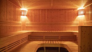 A wooden sauna with benches and two wall-mounted lights. - Relax and Play: Indoor Pool, Cycling Nearby, Game Room & Free Parking (Heelsum)