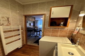A bathroom with a white sink, a mirror, and a towel rack. - Stunning Alpine Base near Termal Bath (Mont-Dore)