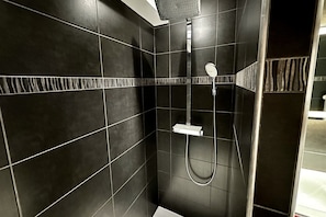 A modern shower with a handheld showerhead and a wall-mounted control panel. - Bright La Bourboule Stay for 4 (La Bourboule)