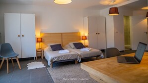 A modern bedroom with two beds, a desk, and a laptop. - Estate with Panoramic Sancy Views (Mont-Dore)