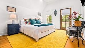 A bedroom with a bed, a nightstand, a lamp, a window, and a door. - New Luxurious & Elite! Steps to Auburn University & Downtown (Auburn)