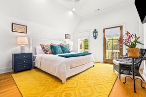 A bedroom with a bed, a nightstand, a lamp, a window, and a door. - New Luxurious & Elite! Steps to Auburn University & Downtown (Auburn)