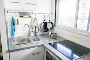 Eine Küche mit zwei Spülen, einem Fenster und einem Geschirrgestell.