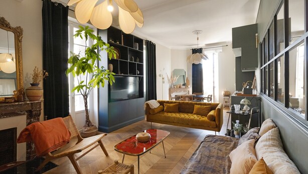 A living room with a sofa, armchair, and a dining table with a red table runner. - Charming Apartment in the Heart of Ajaccio (Ajaccio)