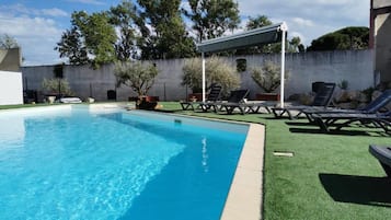 Seasonal outdoor pool, open 1:00 PM to 9:30 PM, pool umbrellas