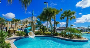 A swimming pool with a water slide, palm trees, and a clear blue sky. - EV_1144 - 4 Bed 3 Bath Townhome with Private Splash Pool (Davenport)