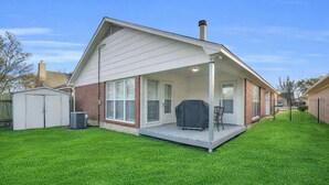 A single-story house with a covered patio, a brick exterior, and a well-maintained lawn. - Pet-Friendly Home w/ Game Room in Montgomery (Montgomery)