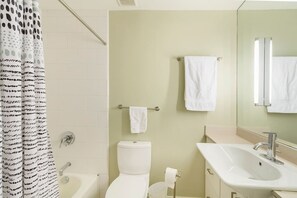 A bathroom with a bathtub, toilet, sink, and a towel rack. - Sojourn on Cherry Lane (Austin)