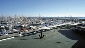A marina with numerous boats docked, a covered walkway, and a clear sky. - 52m² Chalet with Terrace in Benicàssim for 4 people (Benicasim)