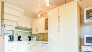 A kitchen with white cabinets, a microwave, and a coffee maker. - Provençal Mazet with Pool, Pets Welcome, Secure Parking (Le Lavandou)