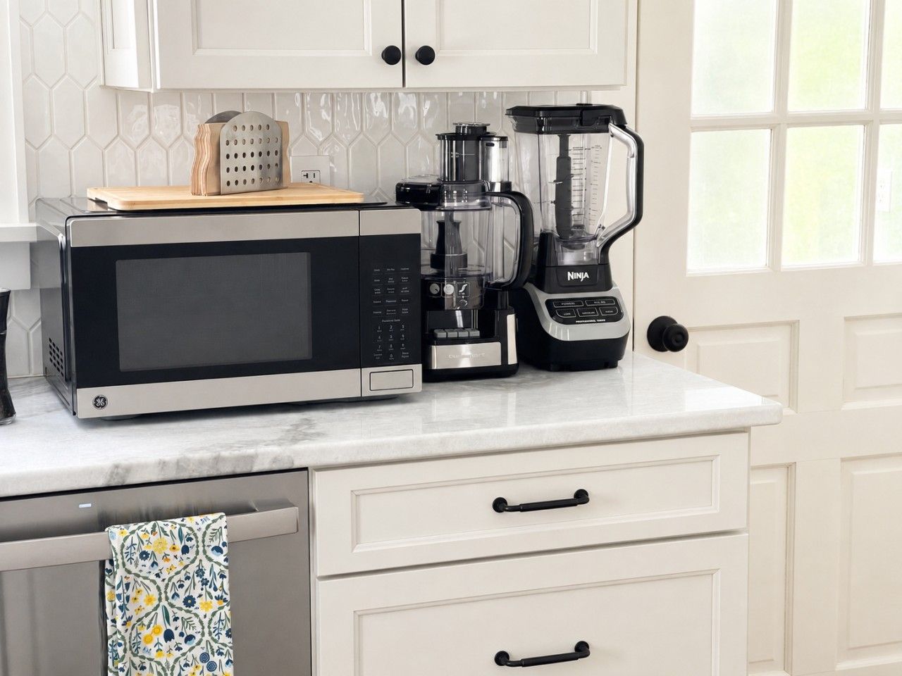 A kitchen with a microwave, coffee maker, and blender on the countertop.