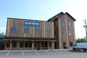 Un bâtiment avec une enseigne indiquant « The Inn Between » et un parking devant.