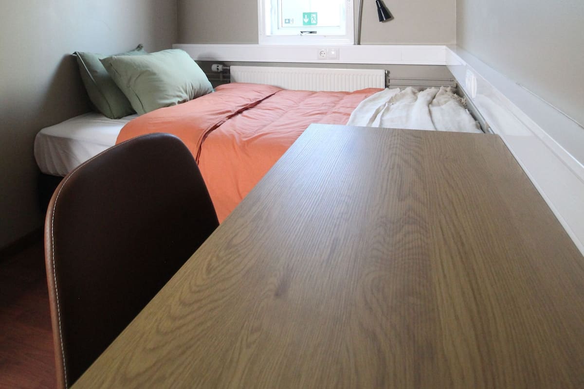 Hypo-allergenic bedding, desk, laptop workspace, blackout drapes