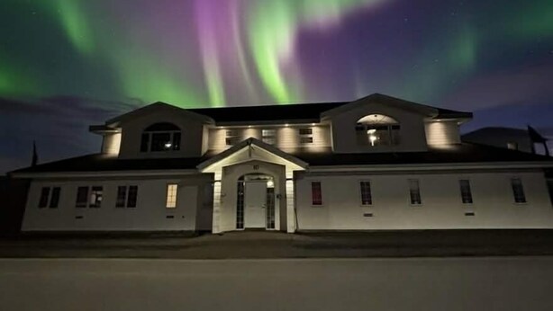 A two-story building with a central entrance and a symmetrical facade. - Nupan Deluxe  (Keflavík)