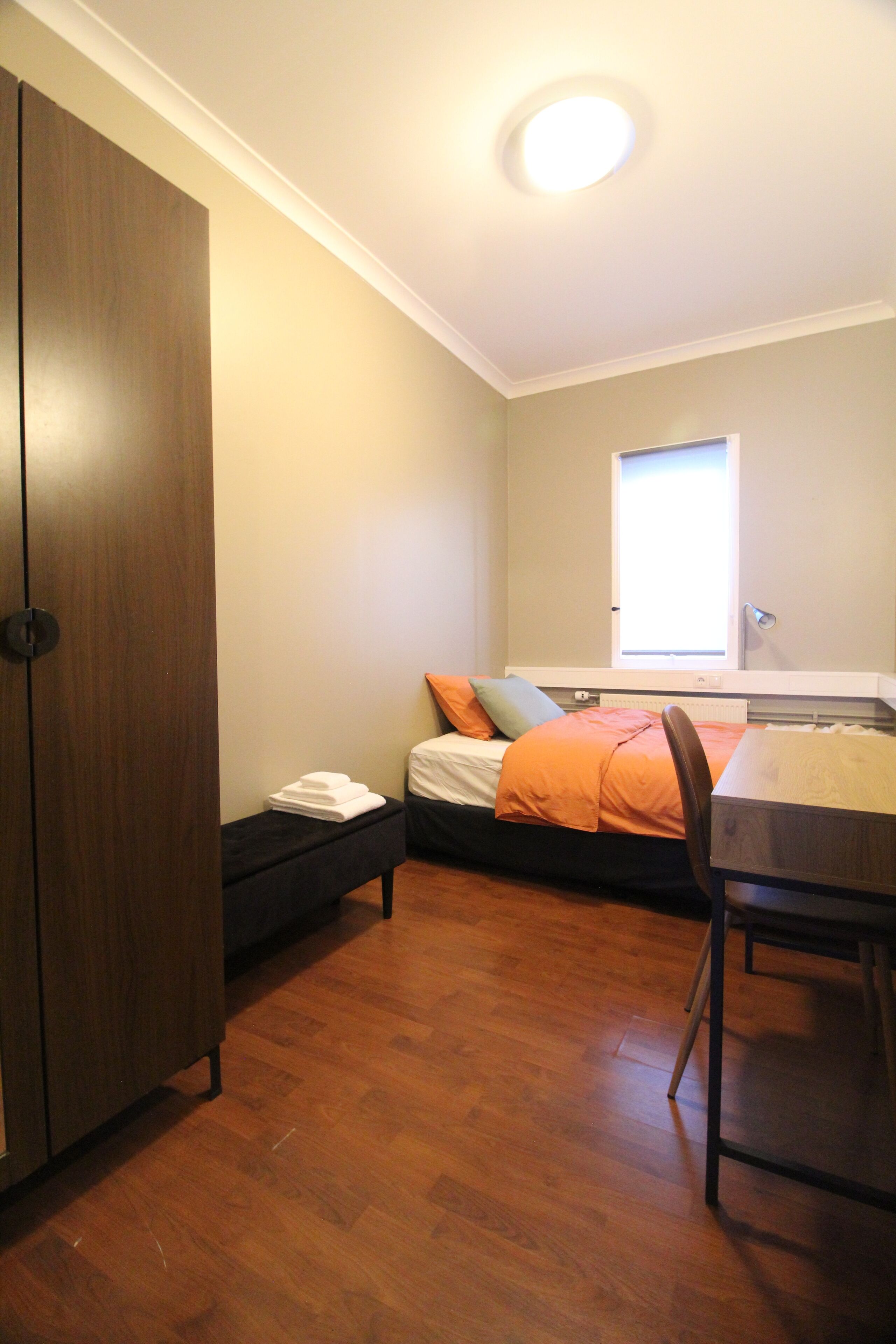 Hypo-allergenic bedding, desk, laptop workspace, blackout drapes