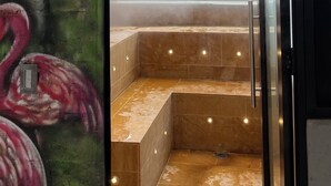 A steam room with a sign reading "Turco Steam Room," a tiled floor, and a glass door. - Modern 2BR Apartment in Helena ✨ Terrace, Jacuzzi & Café (Medellín)