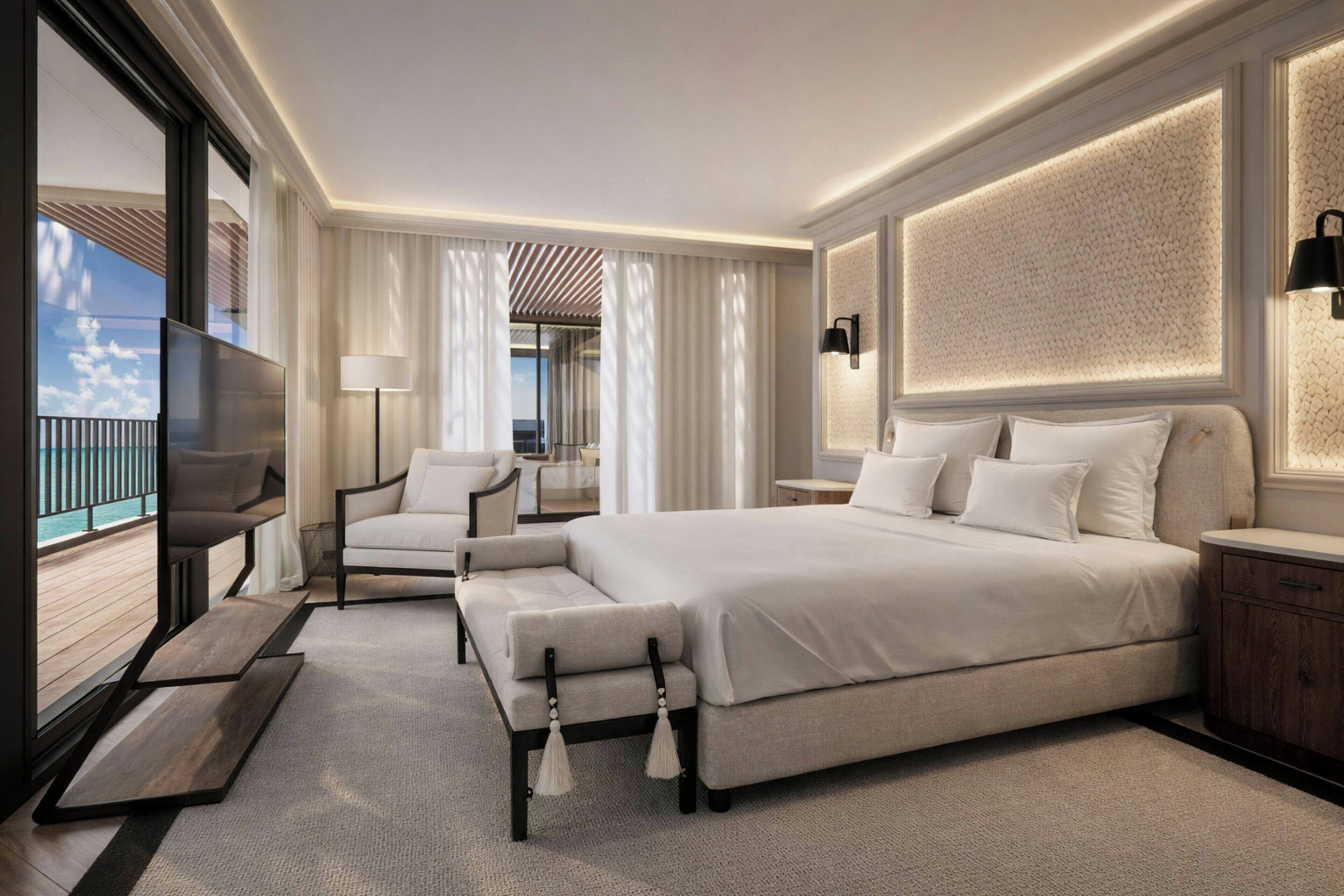 Ett modernt hotellrum med en stor säng, en soffa, en TV och en balkong med utsikt.