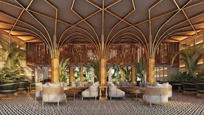 A spacious lobby with a geometric ceiling design, seating areas, and tropical plants. - The Pyrmont Curaçao, An Autograph Collection, All-Inclusive Resort Adults Only (Willemstad)