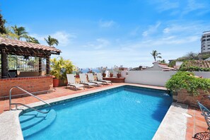A swimming pool with a tiled deck, lounge chairs, and a pergola. - 4BR Private Oceanview Retreat, Steps from Malecon & Zona Romantica (Puerto Vallarta)