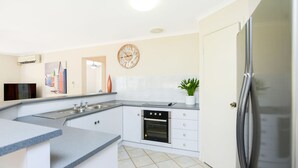 A modern kitchen with a built-in oven, a sink, and a refrigerator. - 2 Marto Court, Normanville (Normanville)