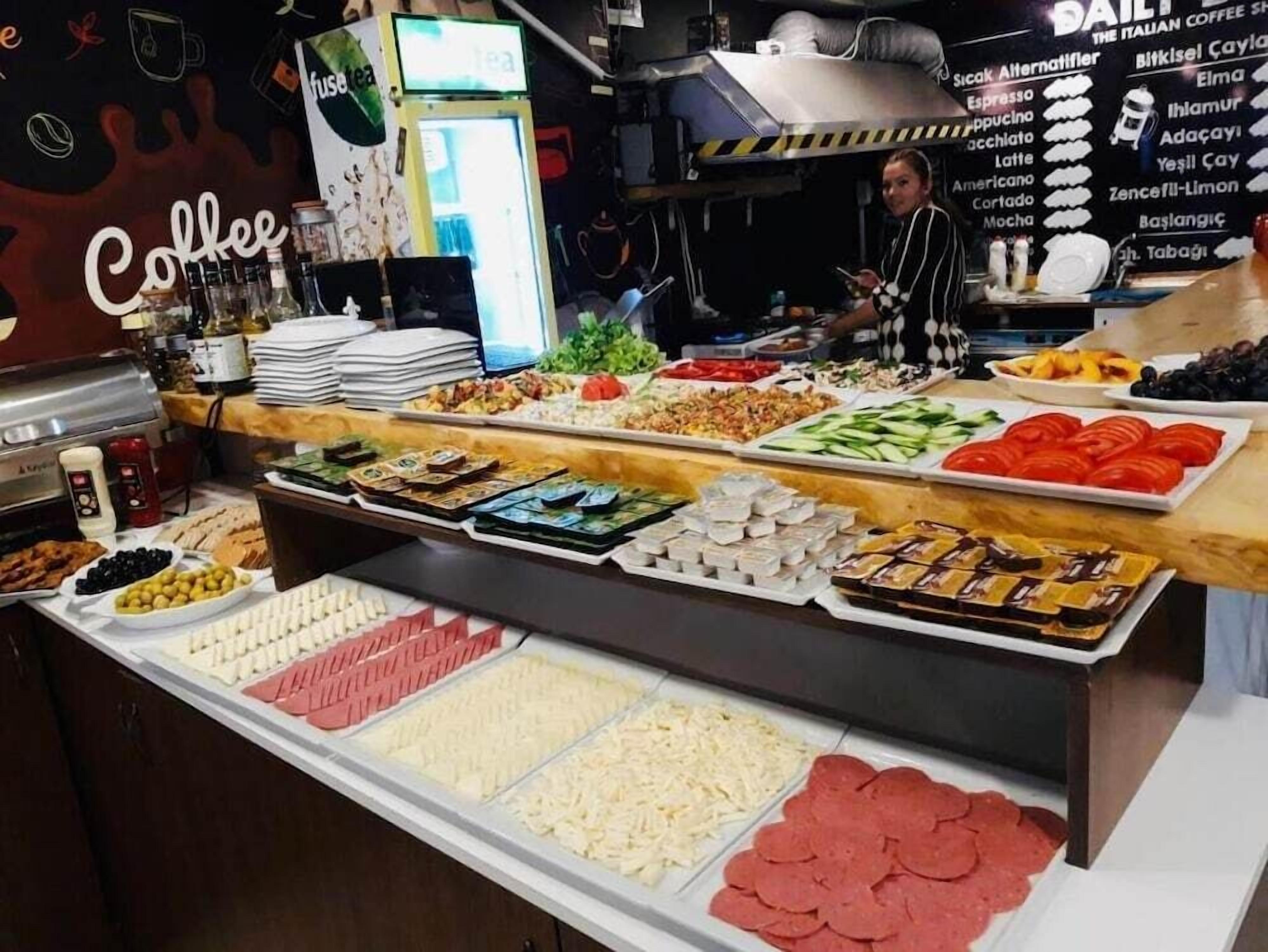 A buffet with various food items including meats, cheeses, and vegetables.