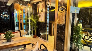 A modern interior with a seating area, a large mirror, and a 'Welcome' sign. - The Little Prince Hotel (Istanbul)