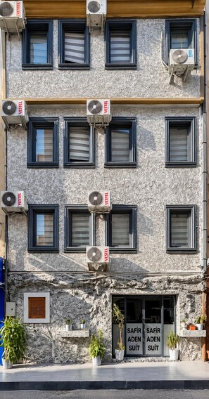 A multi-story building with air conditioning units and a sign indicating a business named 'VESTEL'. - SAFİR HOUSE (Bursa)