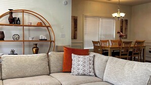 A living room with a sectional sofa, a glass coffee table, and a patterned rug. - 5 min Walk to GWCC, Mercedes-Benz, World Cup! (Atlanta)