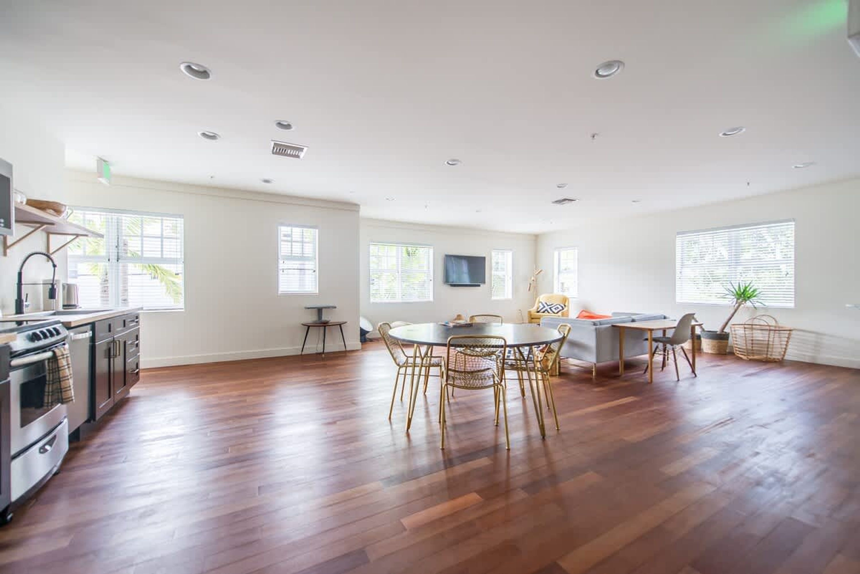A spacious living area with a kitchen, dining table, and seating.