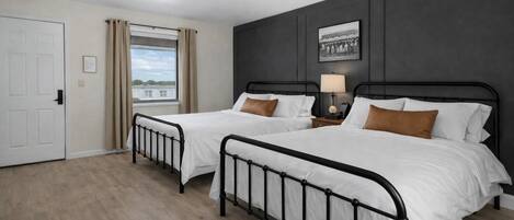 Desk, laptop workspace, blackout drapes, iron/ironing board