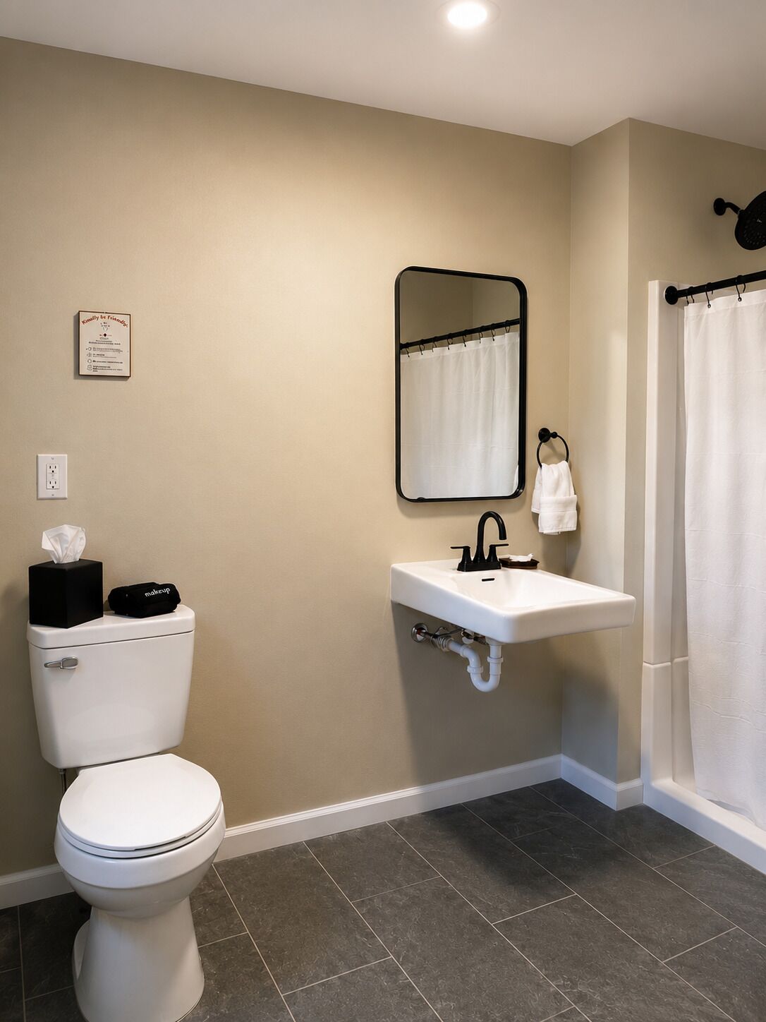 A bathroom with a toilet, sink, mirror, and shower curtain.