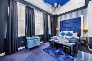 A bedroom with a large bed, a dresser, a nightstand, and a ceiling light fixture. - Stunning Super king & Double Bed Apartment|Central London|Oxford St|Bond St (London)