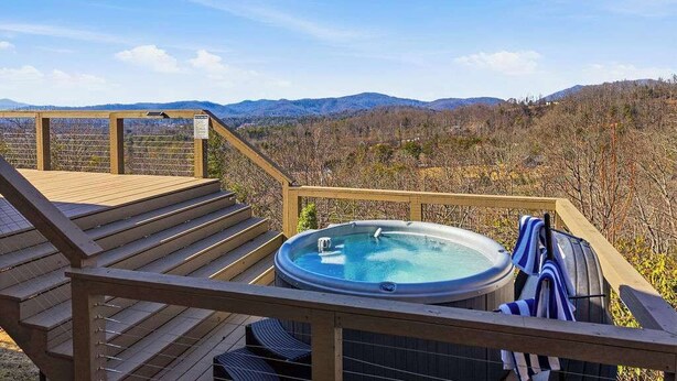 A hot tub on a wooden deck with a scenic mountain view. - Mtn Views | Stargazing Dome | Hot Tub | Sleeps 20 (Fairview)