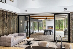 A modern living room with a sofa, a coffee table, and a fireplace.
