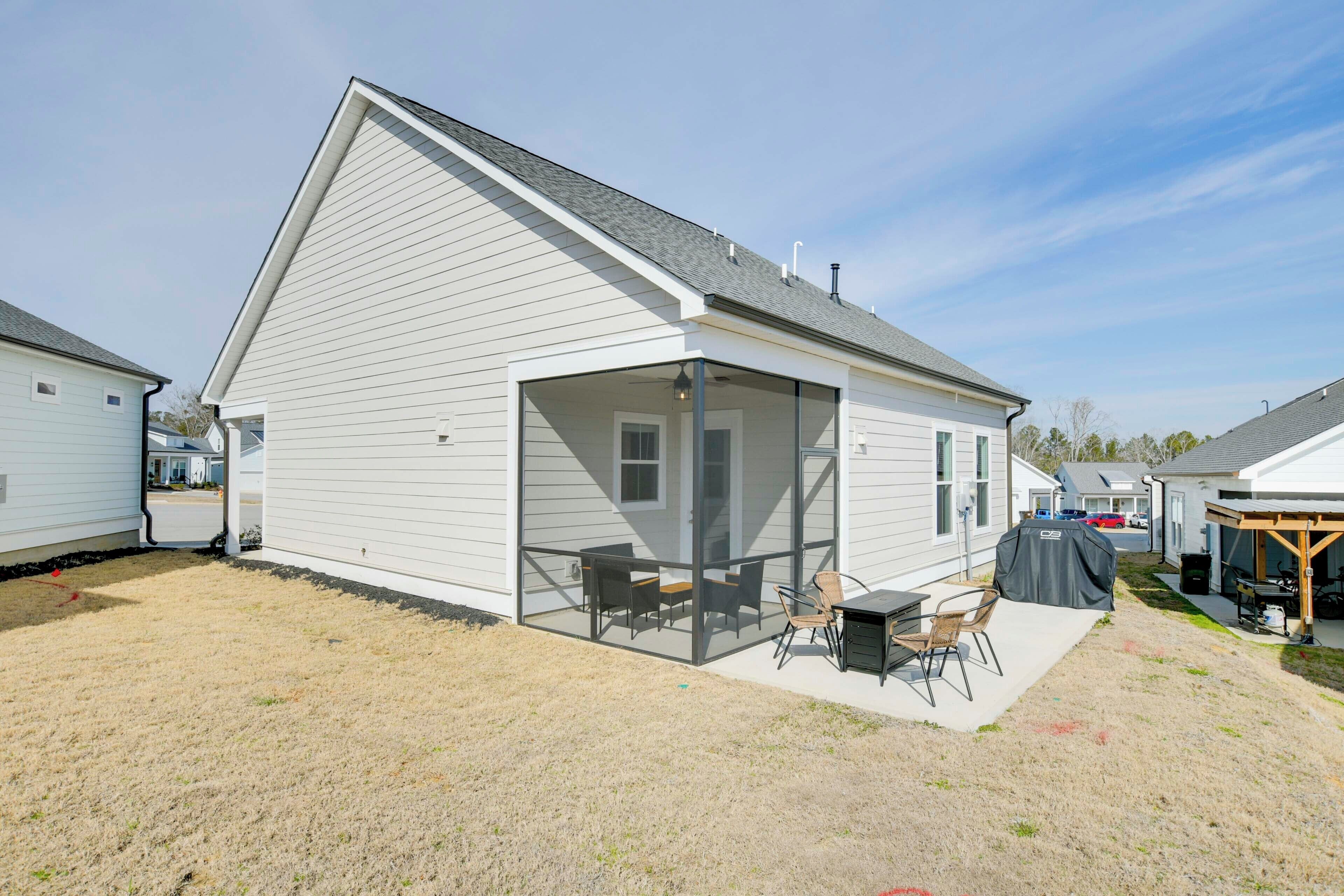 A single-story house with a covered patio area, a small deck, and a garage.