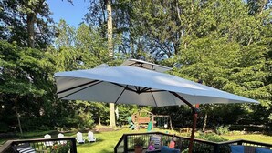 A deck with outdoor furniture, including sofas and a dining table, surrounded by a large umbrella. - 1.7 Miles from PGA Championship - tremendous outdoor space with back deck (Berwyn)