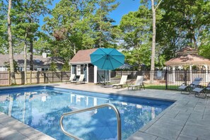 A swimming pool with lounge chairs and a gazebo in a backyard setting. - Private Pool, Central AC, Dog Friendly! (Barnstable)