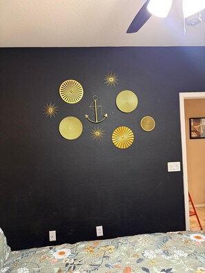 A black wall with gold decorative elements, including an anchor and sun-like patterns. - South Mountain Reserve (Phoenix)