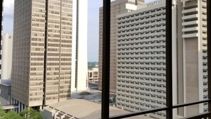 A view of a hotel with multiple high-rise buildings in the background, including a Marriott and a Hyatt Regency. - 1BR Condo w/City Views by Peachtree (Atlanta)