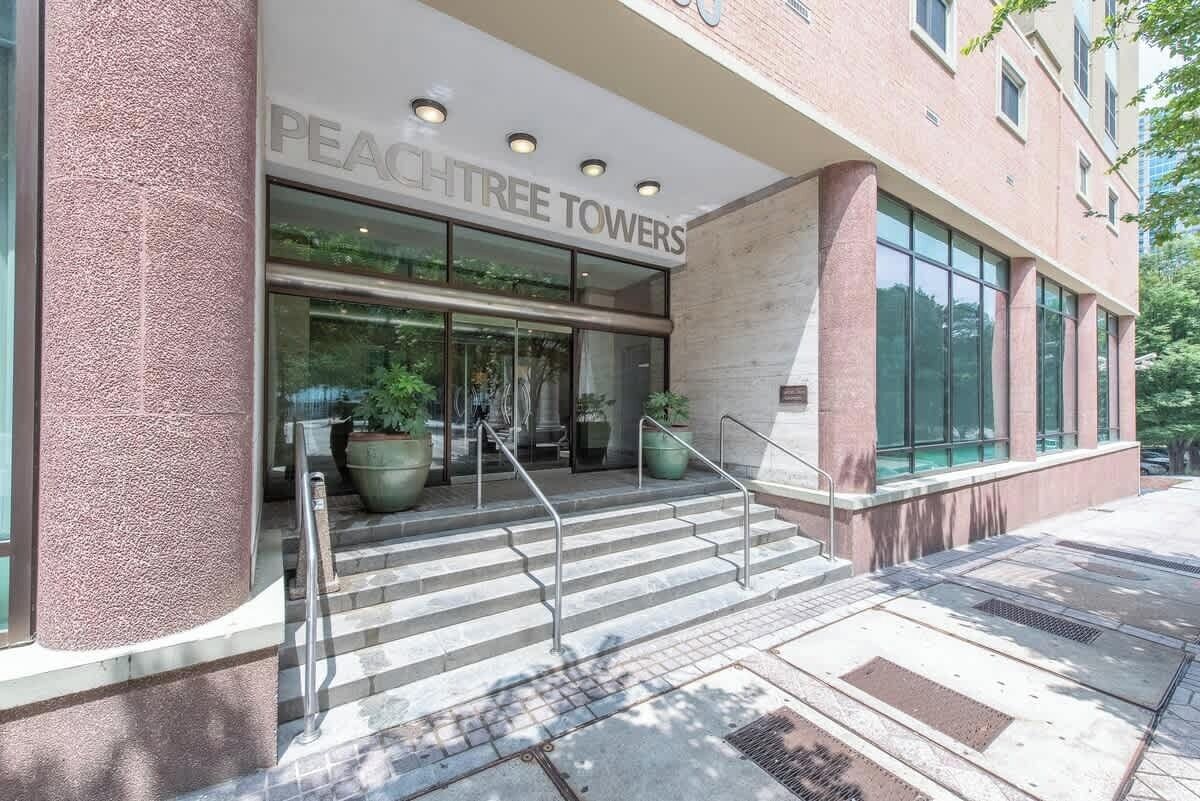 The exterior of a building with a sign reading "PEACHTREE TOWERS".