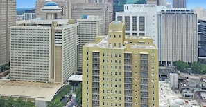 A high-rise building with multiple floors, a prominent entrance, and a large glass facade. - Stylish ATL High-Rise w/ Free WiFi (Atlanta)