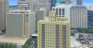 A high-rise hotel with a modern design, featuring a prominent lobby and multiple floors. - Central 1BR w/ Walkable Hotspots (Atlanta)