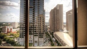 A high-rise building with multiple floors, large windows, and a visible logo on the side. - Cozy High-Rise Condo Near AmericasMart (Atlanta)