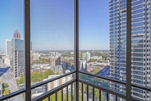 A high-rise building with a view of a cityscape through large windows. - Cozy High-Rise Condo Near AmericasMart (Atlanta)