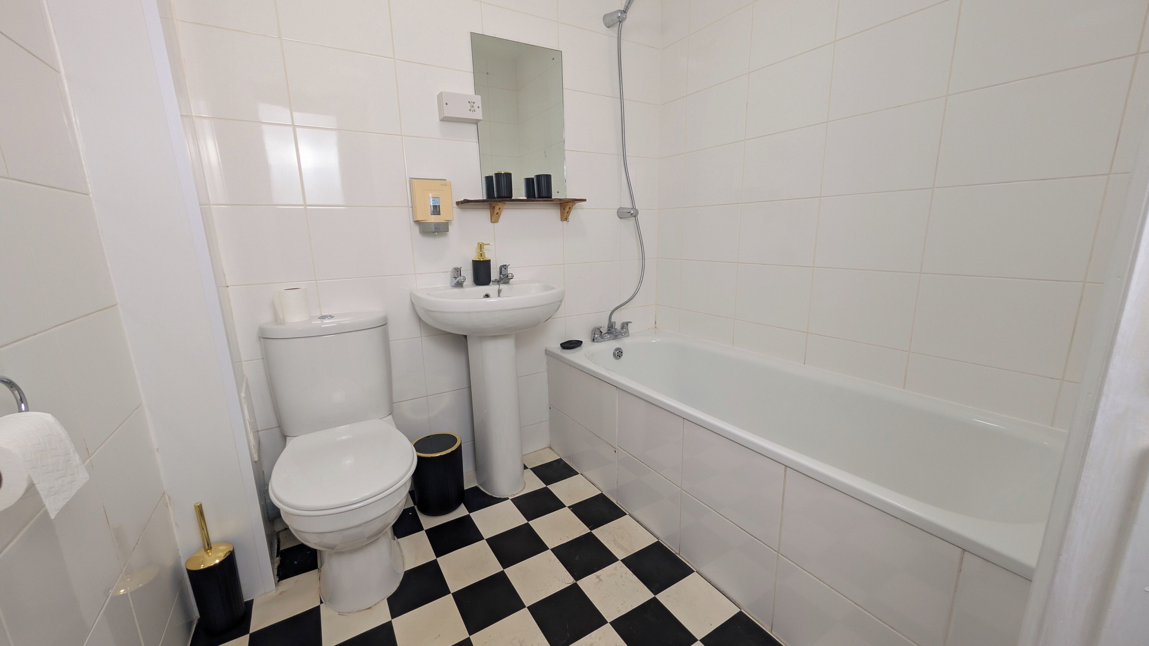 A bathroom with a toilet, sink, and bathtub.