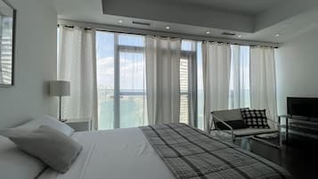 Basic Studio Suite, 1 Queen Bed | Living area | 65-inch TV with digital channels