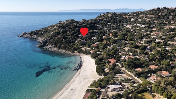 An aerial view of a coastal town with a beach, houses, and a red heart symbol. - Villa Serena by the sea (MARACALAGONIS)